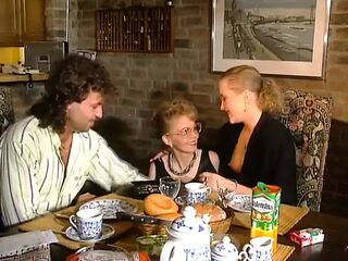 2 marvelous German gals sharing a loaded sausage on the kitchen table